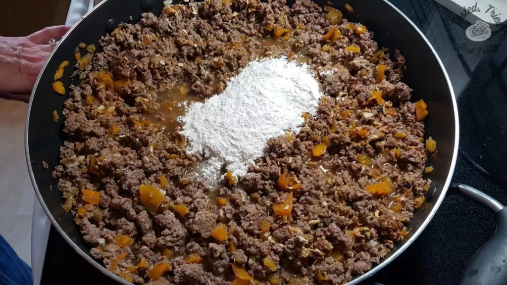 flour added to ground beef and vegetable mixture for delicious perogy casserole