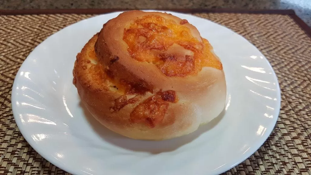 Tasty Garlic Cheese bun on a white plate.