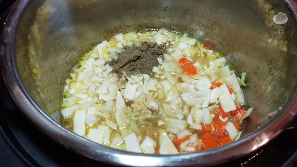vegetables in an instant pot ready for chicken noodle soup
