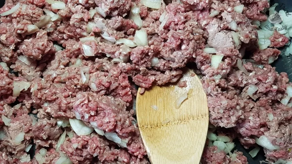 extra lean ground beef and onions in a frying pan.