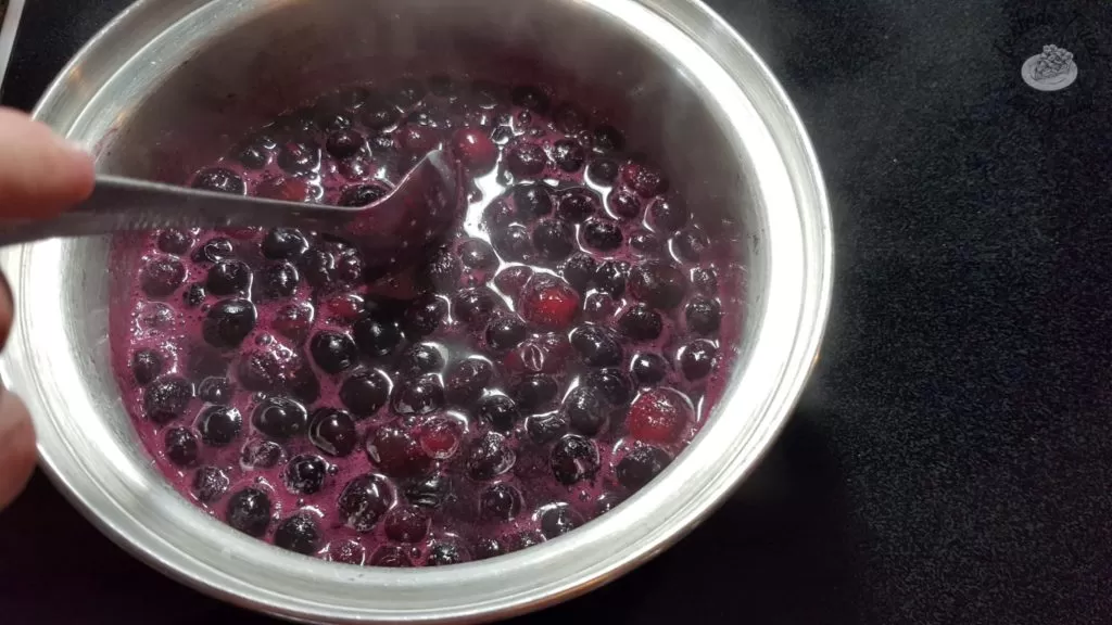 blueberries in a small saucepan being cooked.