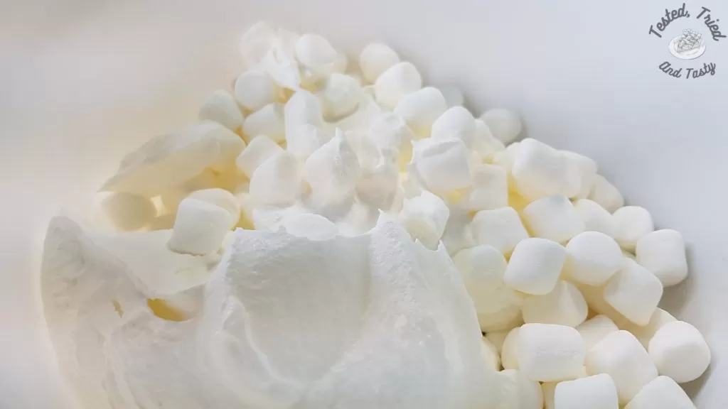 Mini marshmallows with dreamwhip in a white bowl.