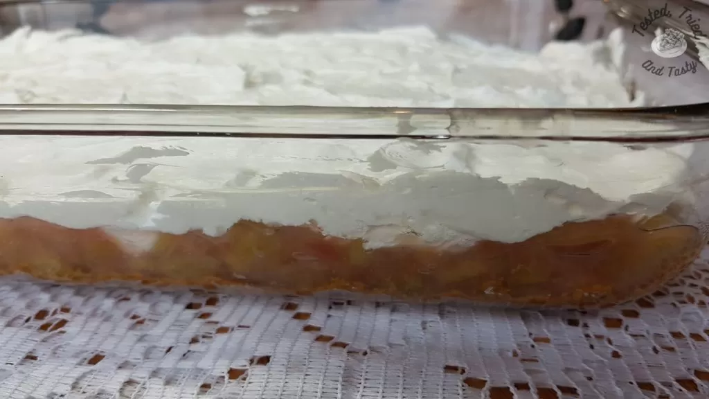 Dream whip/mini marshmallow layer on top of rhubarb layer for rhubarb torte with pudding.