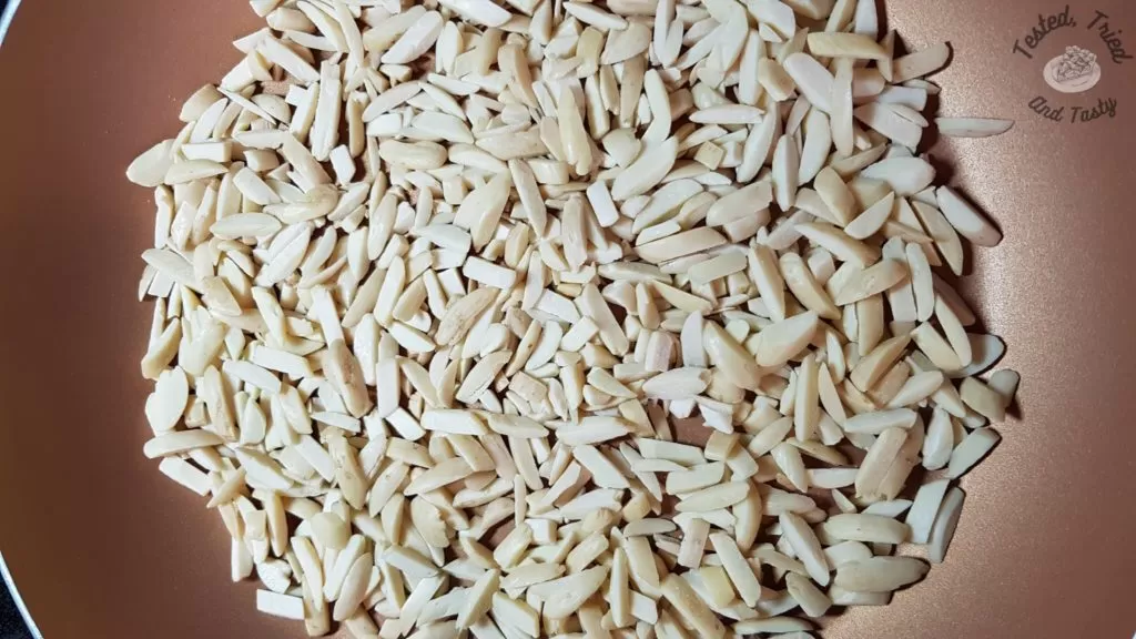 slivered almonds in a frying pan