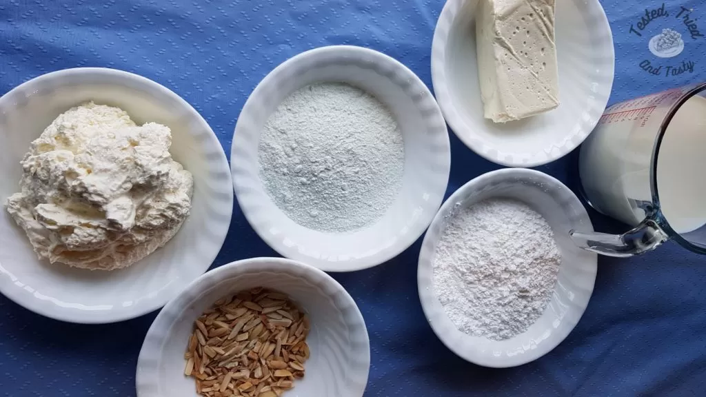 Ingredients for pistachio pudding dessert on a blue tablecloth.