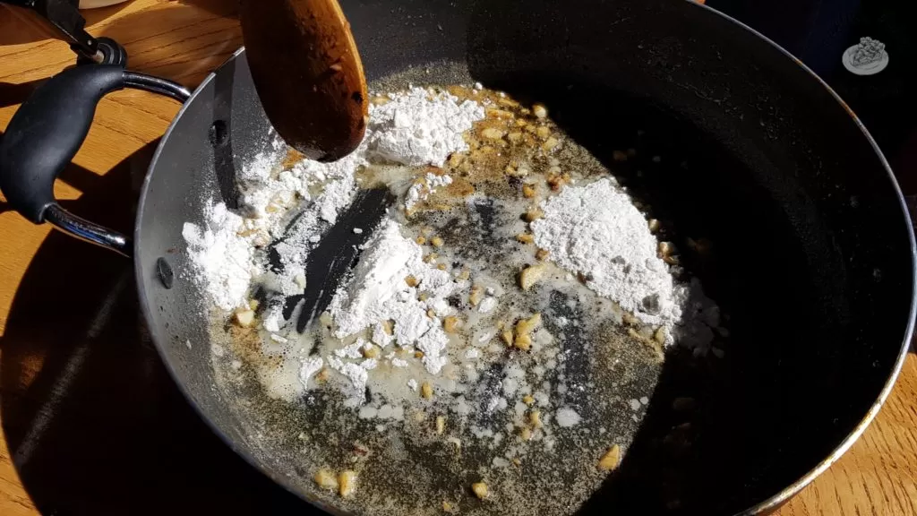 Flour added to butter and garlic in a saucepan
