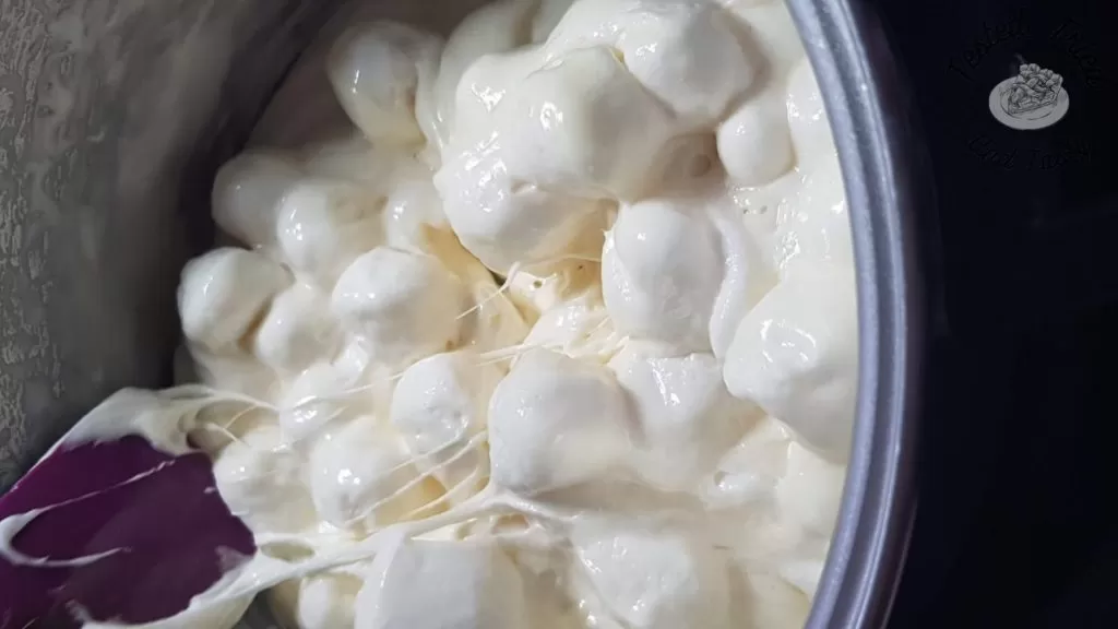 Stirring the marshmallows and the butter in a saucepan.