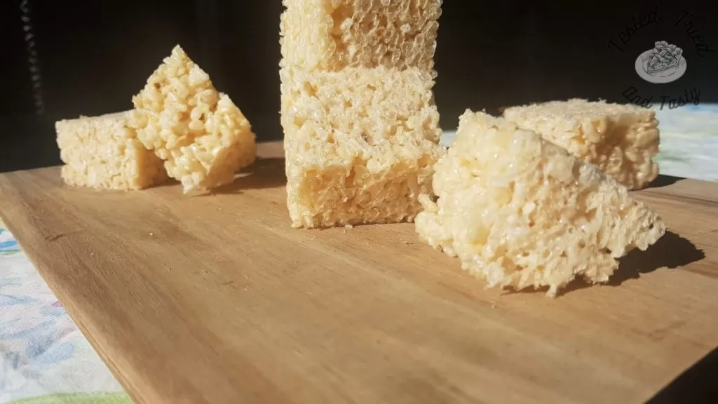 rice krispies treat recipe on a wooden cutting board.