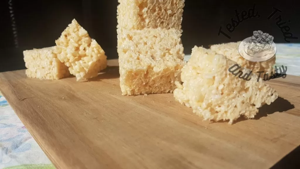 Rice Krispies Treats recipe on a wooden cutting board.