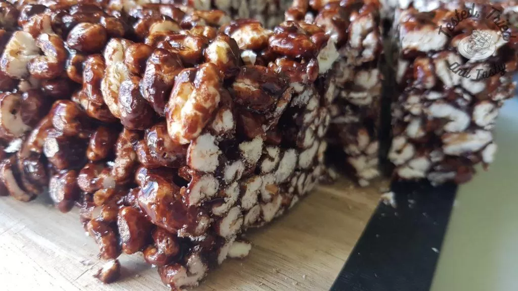 Puffed wheat squares on a wooden cutting board.