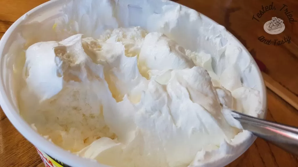 Whipped topping in a container.