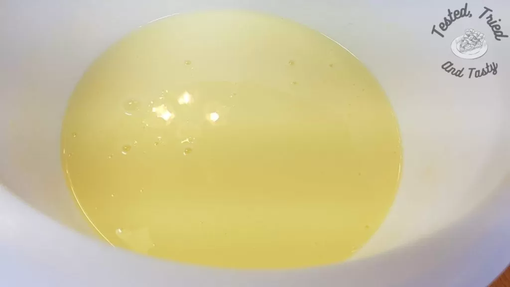 Vanilla pudding in a white plastic bowl.