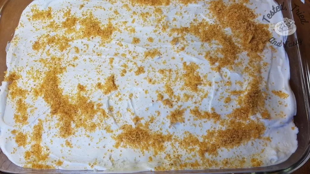 Sprinkle of graham crumb crust on banana cream pie bars.