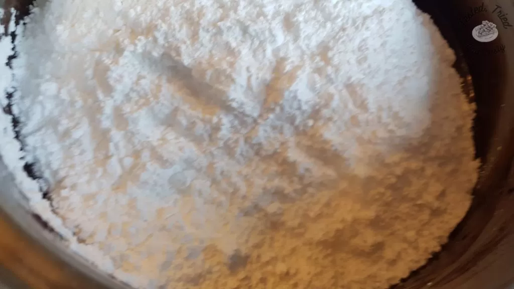 Icing sugar added to the butter, milk and cocoa mixture.