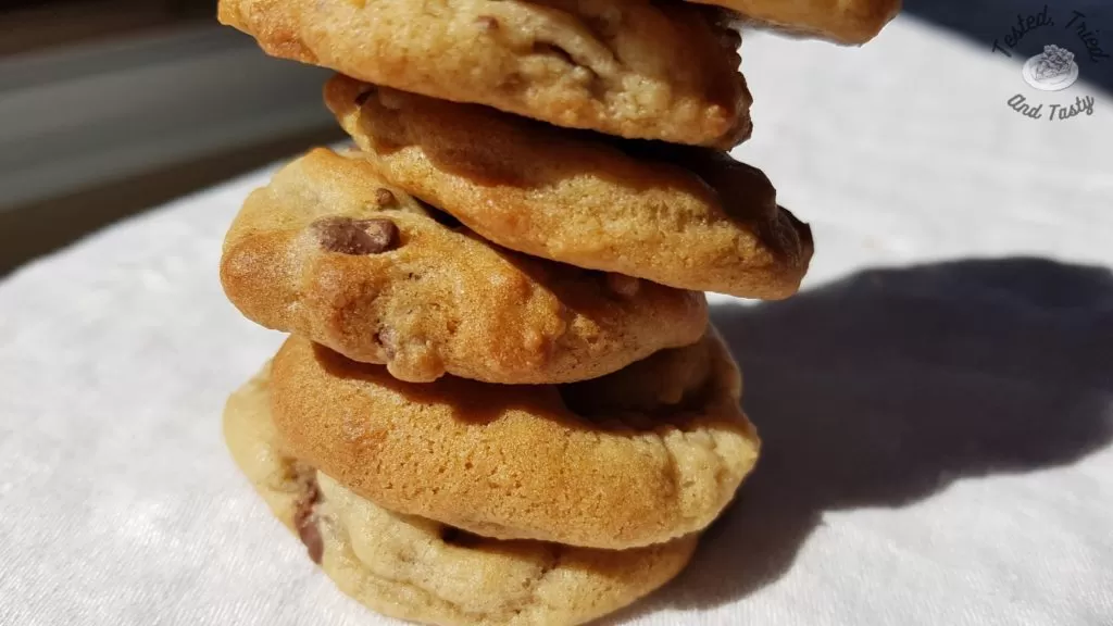 chocolate chip cookies on a white tablecloth.