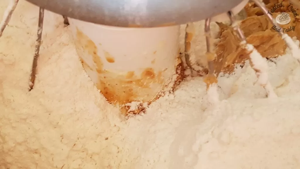Flour baking soda and salt added to peanut butter mixture.