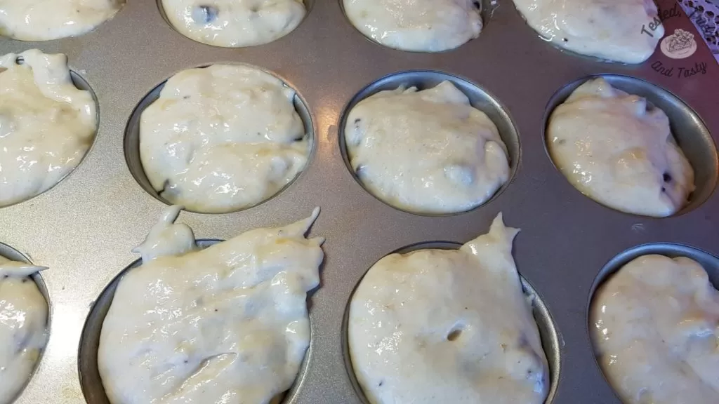 Muffin tin filled with batter ready for baking.