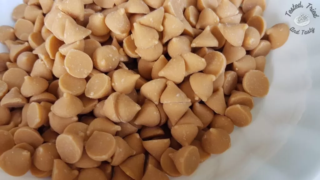 Butterscotch chips in a white bowl.