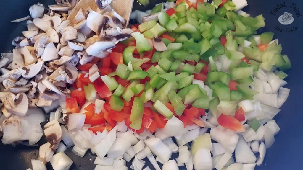 Vegetables being sauteed for breakfast hashbrown casserole.