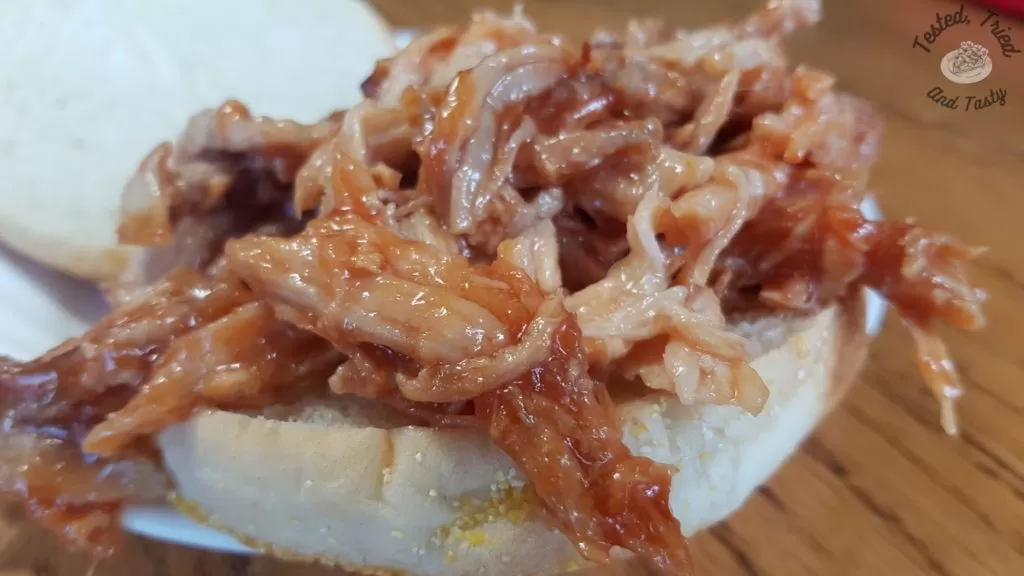 Easy oven cooked pulled pork on a bun.