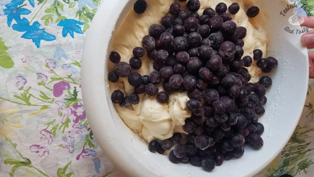 Blueberries added to muffin batter.