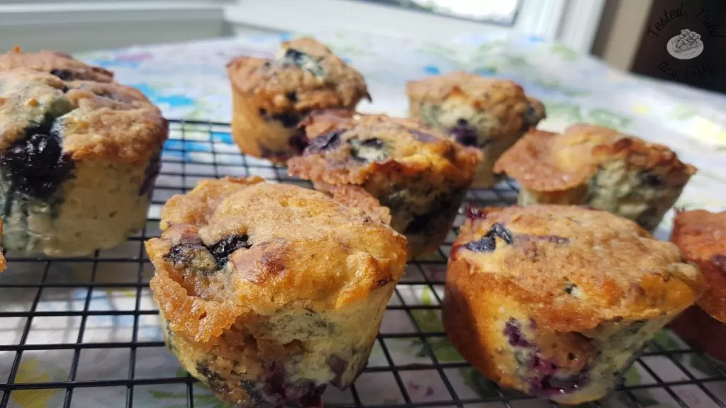 Blueberry muffins on a wire cooling rack.