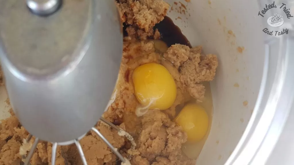 eggs and vanilla added to cookie dough in a bosch mixer.