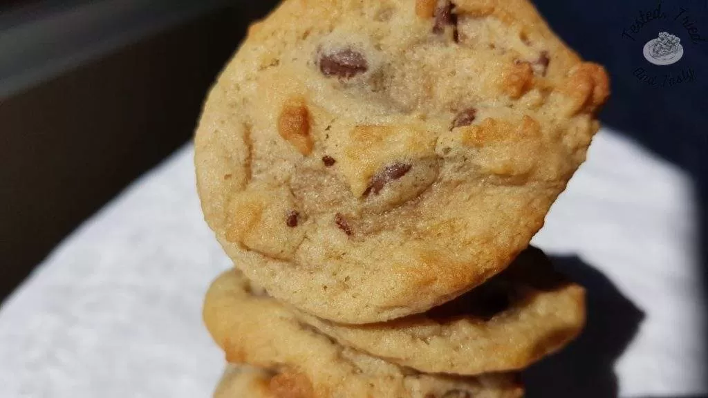 Chocolate chip cookies on a white tablecloth.