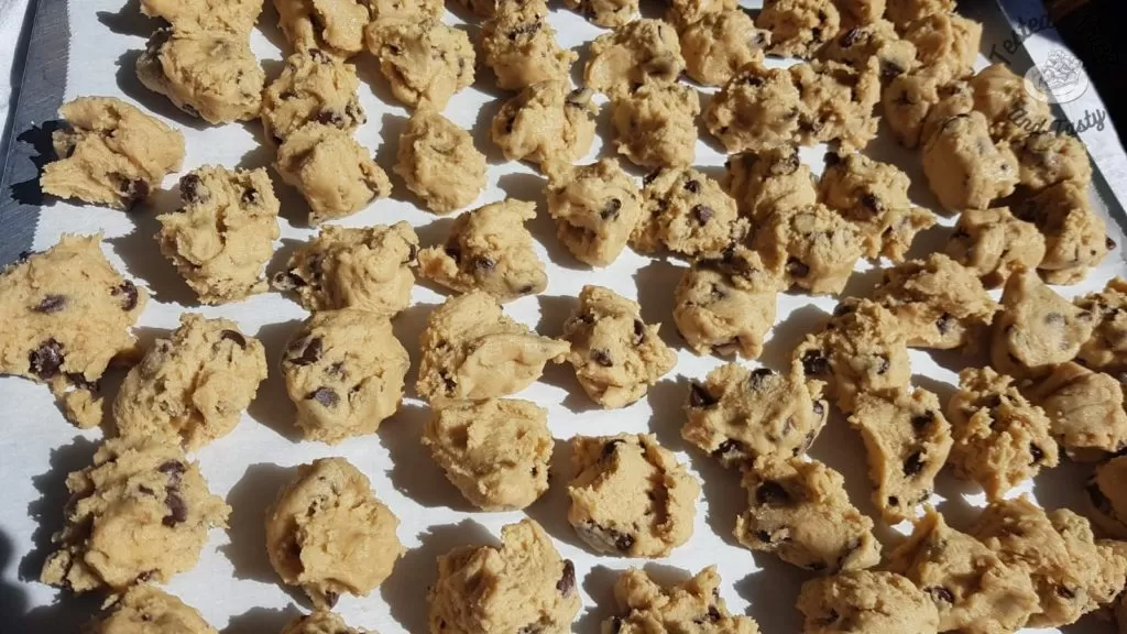 dough balls ready to be frozen on a cookie sheet.