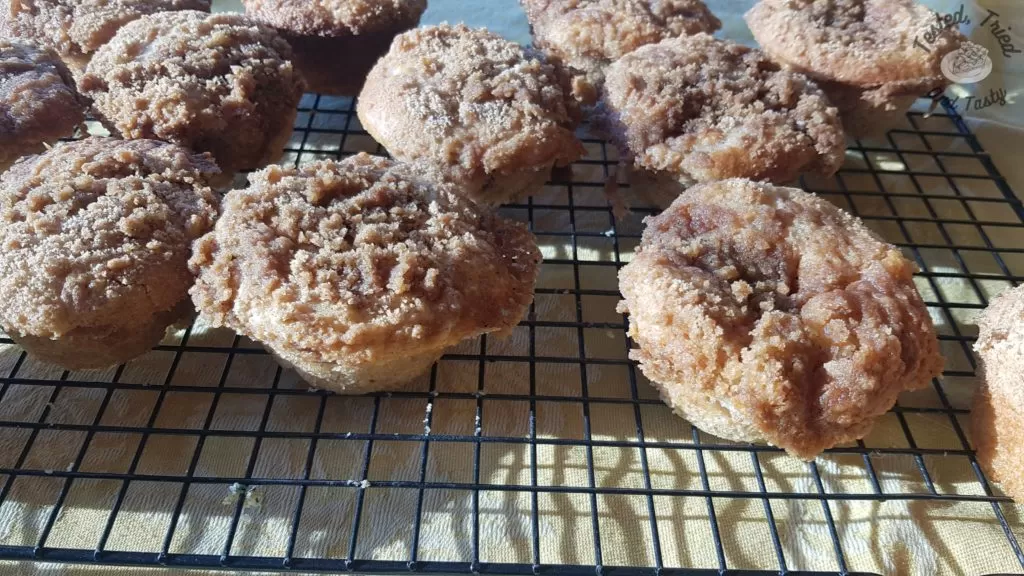 Apple streusel muffins on a wire cooling rack.