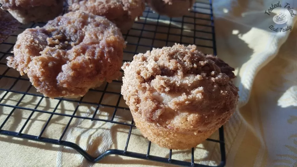 Close up of apple streusel muffins on a wire cooling rack.