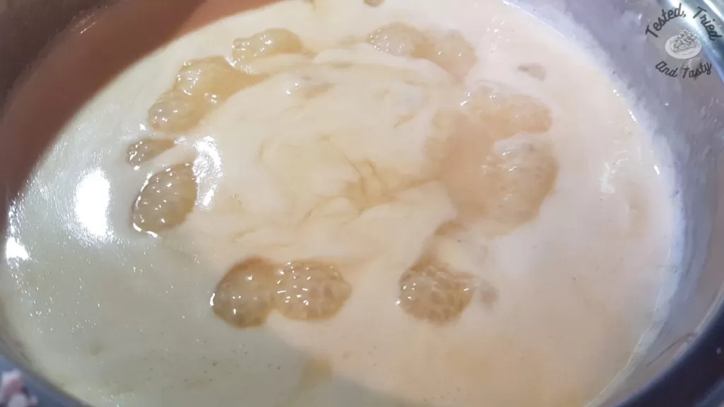 Boiling the evaporated milk, powdered sugar, corn syrup and butter.