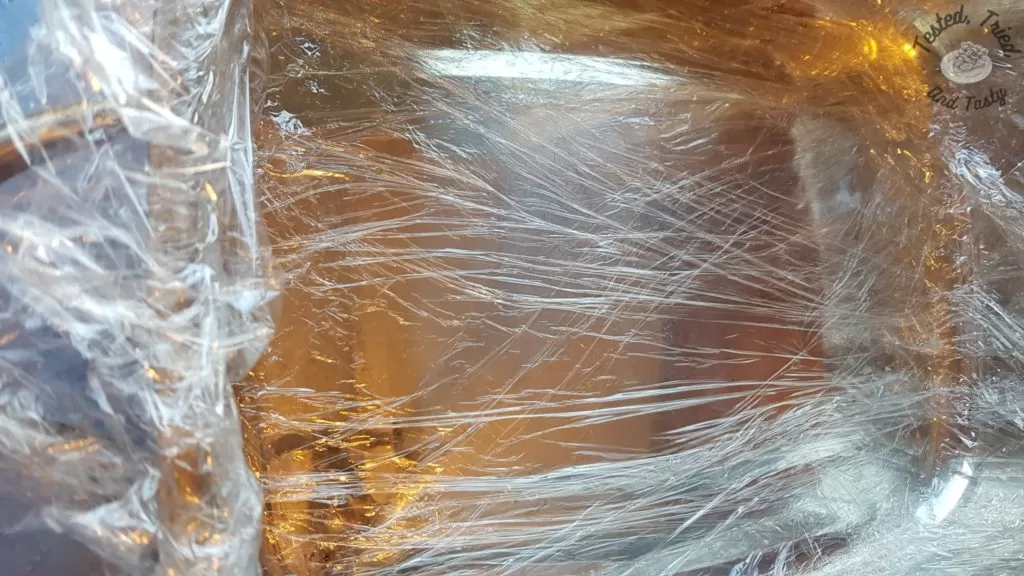 Saran wrap on pan ready for the ice cream.