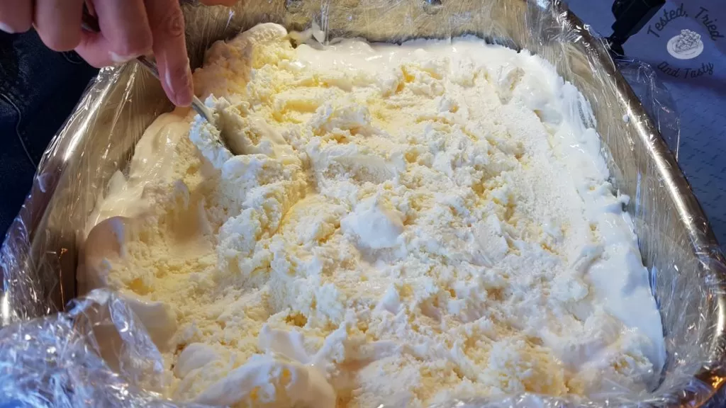 Softened vanilla ice cream spread in large roaster.