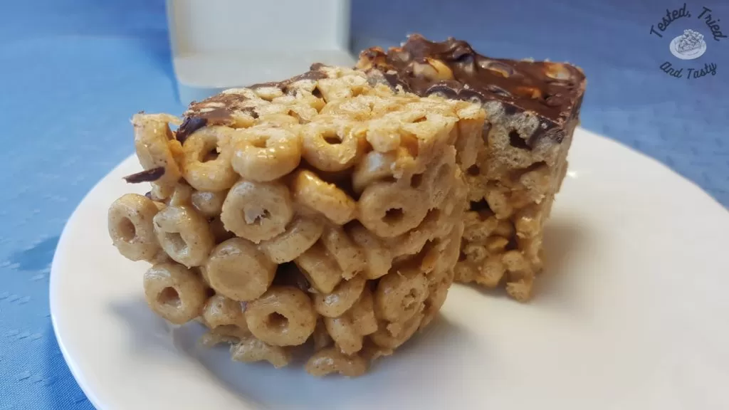 Peanut butter cheerio bars on a white plate.