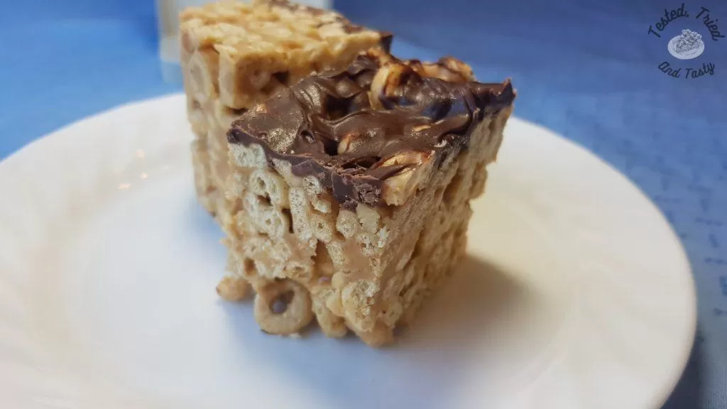 Peanut butter cheerio bars on a white plate.