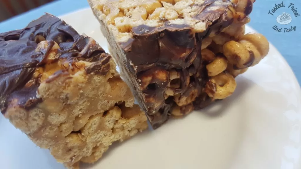 Peanut butter cheerio bars on a white plate.