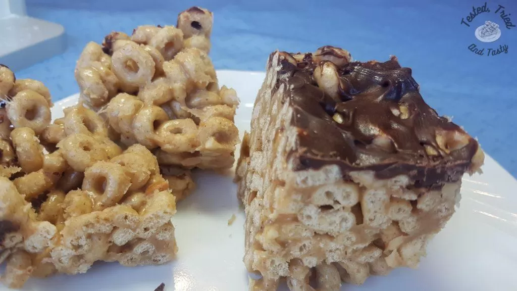 Peanut butter cheerio bars on a white plate.