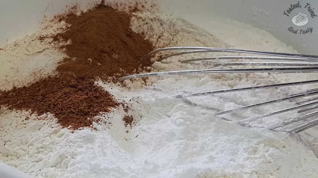 Flour baking powder, nutmeg, cinnamon, and salt in a large bowl.