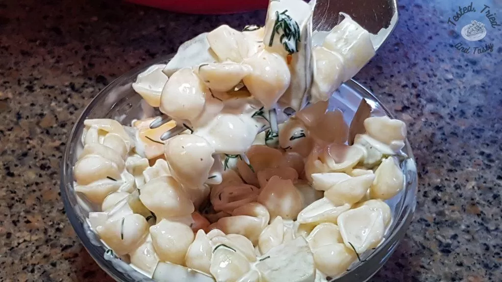 Taking a bite of dill pickle pasta salad.