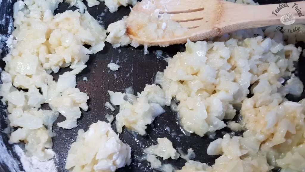 Flour with cooked onions and garlic in a large saucepan.