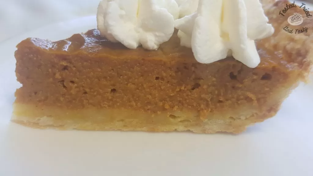 Pumpkin pie with sweetened vanilla whipped cream.