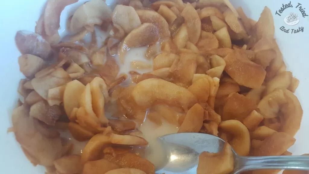 Cornstarch being added to the apples.