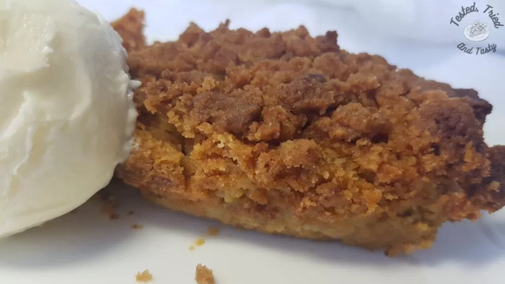 Pumpkin dessert with vanilla ice cream on a white plate.