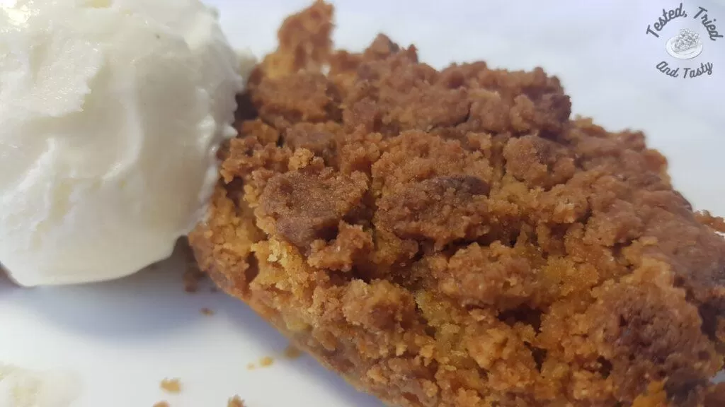 Pumpkin dessert with vanilla ice cream on a white plate.