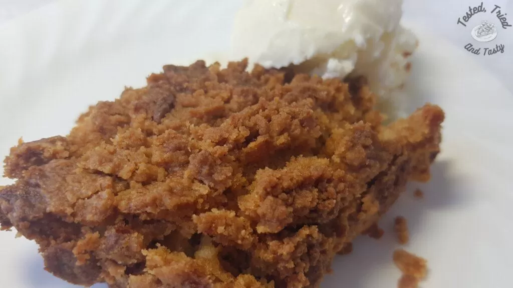 Pumpkin dessert with vanilla ice cream on a white plate.