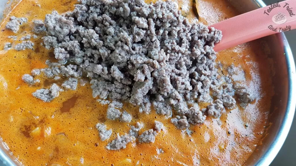 Ground beef added to ground beef soup.