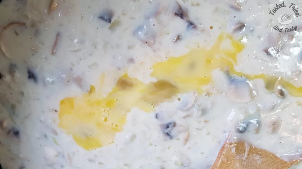 eggs being added to the creamy mixture.