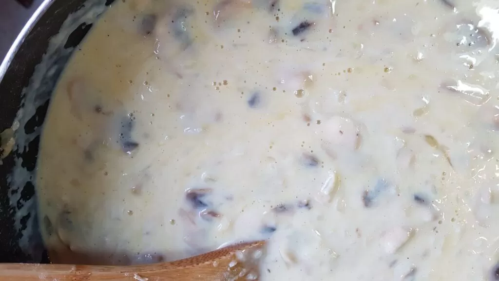 Milk added to the thickened onions and mushrooms
