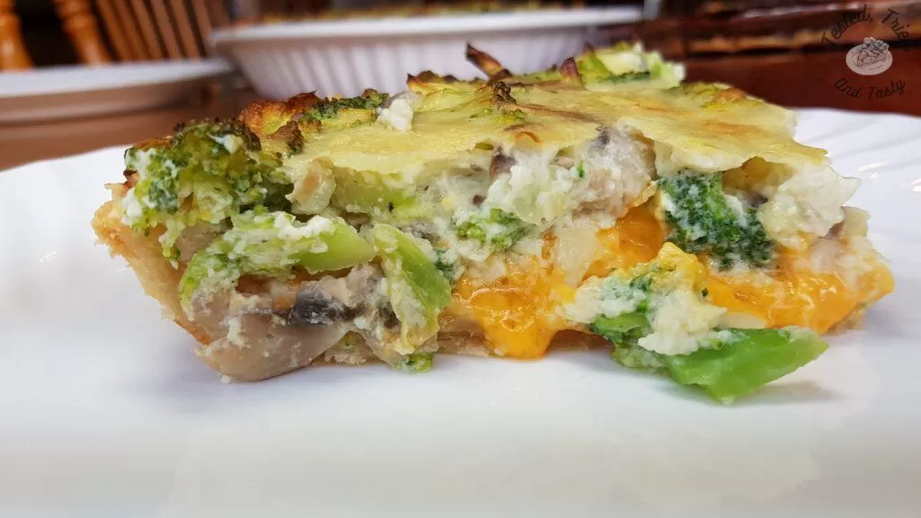 Broccoli quiche recipe on a white plate.